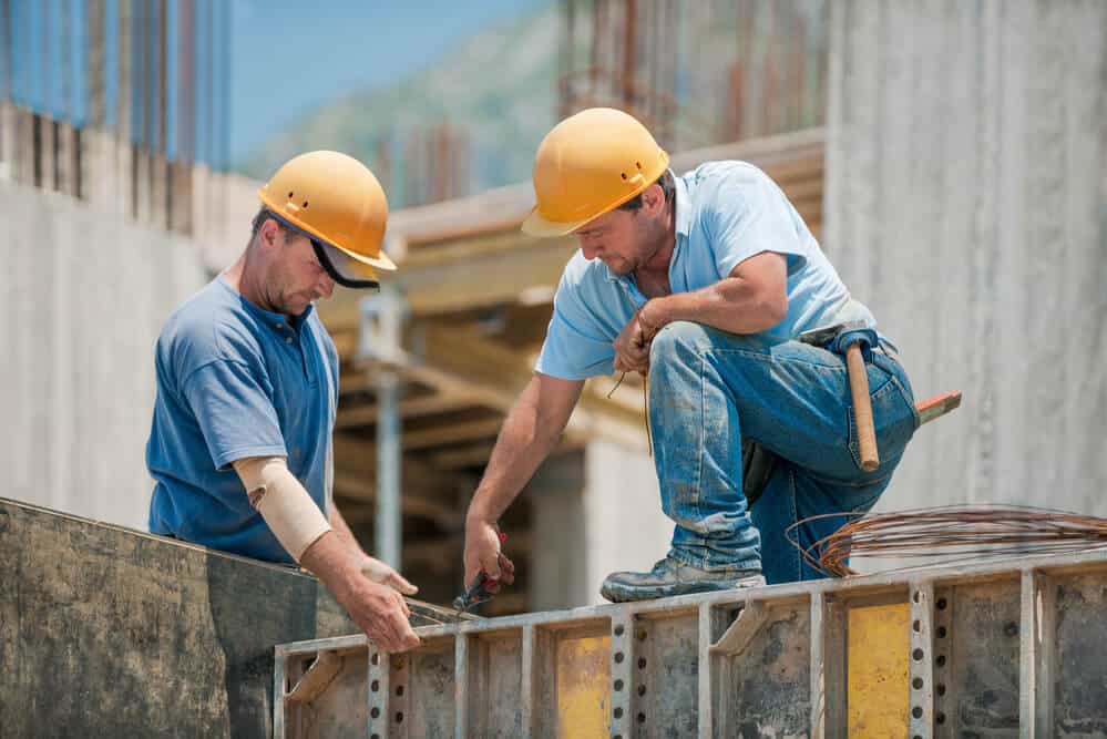 dois homens trabalhando na construção civil